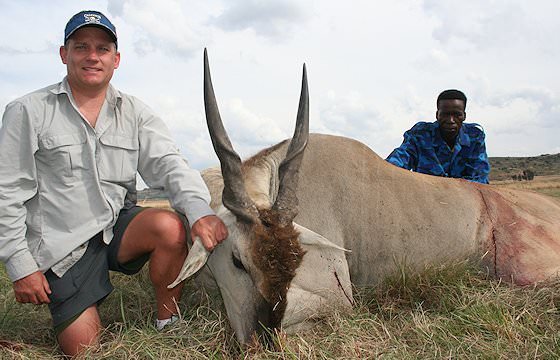 A hunter presents his eland trophy for a photograph.