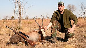 A hunter holds up the head of his blesbok trophy.