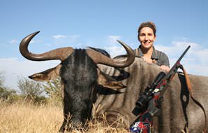 A huntress with her blue wildebeest trophy.