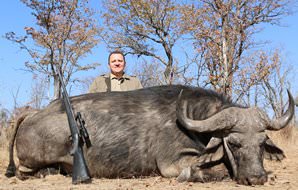 A hunter with his Cape buffalo trophy.