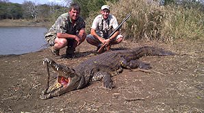 A hunter with his crocodile trophy and professional hunter.