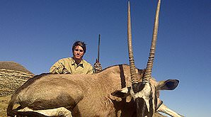 A hunter smiles above his gemsbok trophy.