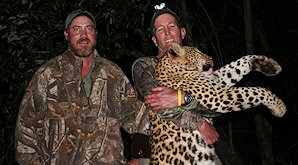 A hunter with his leopard trophy and professional huner.