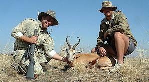 A hunter poses with his springbok trophy and professional hunter.