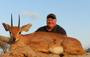 A steenbok trophy is presented for a photograph.