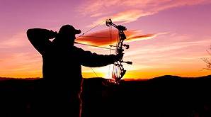 A hunter draws his bow.