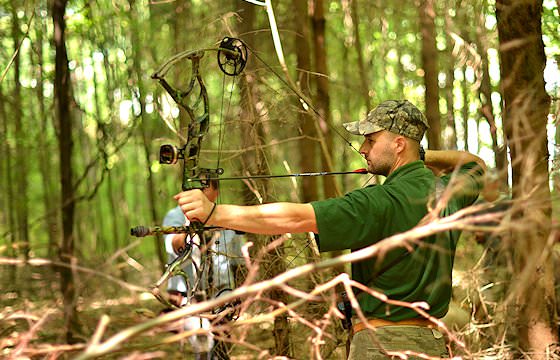 A bow hunter prepares to take his shot.