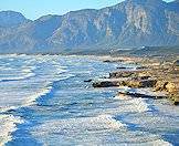 A backdrop of mountains frame the shores of the Cape peninsula.