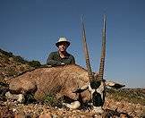 A hunter props up his impressive gemsbok trophy.