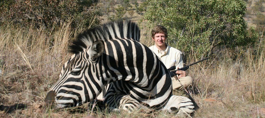 A proud hunter with his Burchell's zebra trophy.