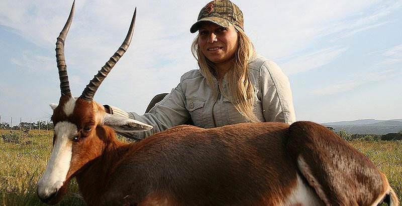 A huntress smiles with her bontebok trophy.