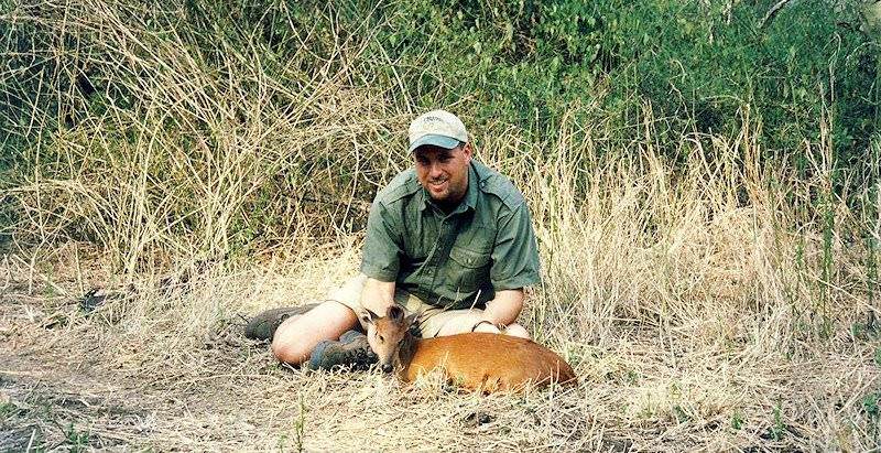 A hunter presents his red duiker trophy for a photograph.