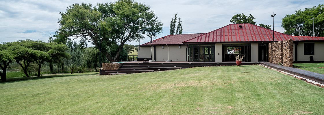 The manicured lawns of the bushveld hunting camp.