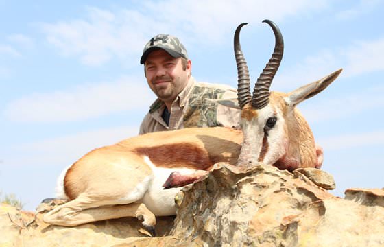 A proud hunter with an impressive springbok trophy.