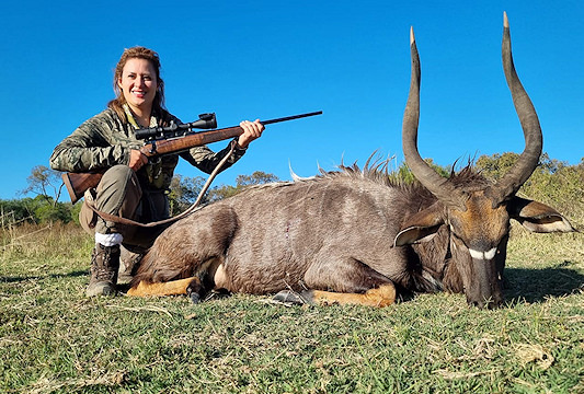 A nyala trophy is presented for a photo.
