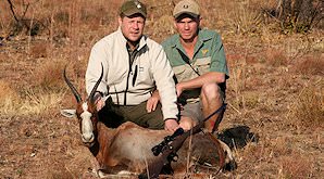 A hunter presents his blesbok trophy for a photograph.