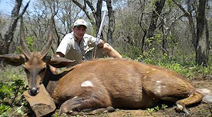 A bushbuck trophy is presented for a photo.