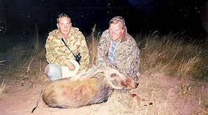 A pair of hunters with a bush pig trophy.