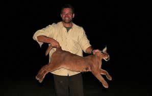 A hunter shows off his caracal trophy.