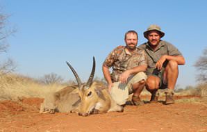 A pair of hunters with a common reedbuck trophy.