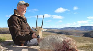 A hunter props up his grey rhebuck for a trophy.