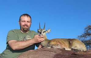 A klipspringer trophy is presented for a photograph.