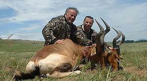 A pair of hunters with their red hartebeest trophies.