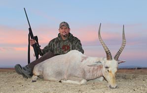A hunter with his white blesbok trophy.