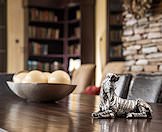 A zebra statuette on a dining room table.