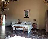 The bedrooms boast high ceilings and tiled floors.