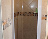 The interior of a bathroom and shower.