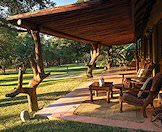 Plush chairs on the patio of the hunting camp.