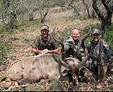A hunting team showcases their kudu.