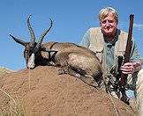 A black springbok trophy presented on an anthill.