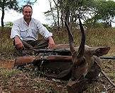 A triumphant bushbuck hunter.