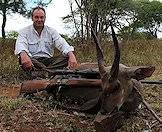 A triumphant bushbuck hunter.