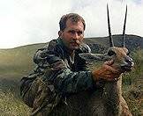 A hunter props up his grey rhebok trophy.