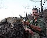 A hunter proudly displays his klipspringer trophy.