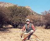 A hunter poses with his mountain reedbuck trophy.
