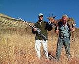 Hunters hold up their mountain reedbuck trophy.
