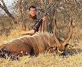 A hunter poses with his nyala trophy.