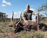 A hunter displays his nyala trophy for a photograph.