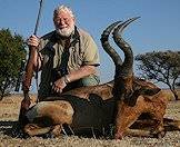 A red hartebeest trophy positioned for a commemorative photograph.
