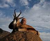 A hunter looks over his springbok trophy.