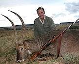 A proud hunter with his waterbuck trophy.