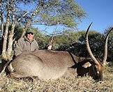 A hunter poses with his waterbuck trophy after the hunt.