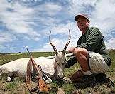A hunter props up his white blesbok trophy for a photograph.