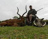 A hunter with his impala and warthog trophies.