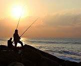 Fishermen prepare to fish from the rocks in Cape Town.