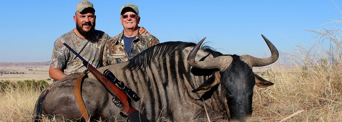 A client poses by his trophy animal.